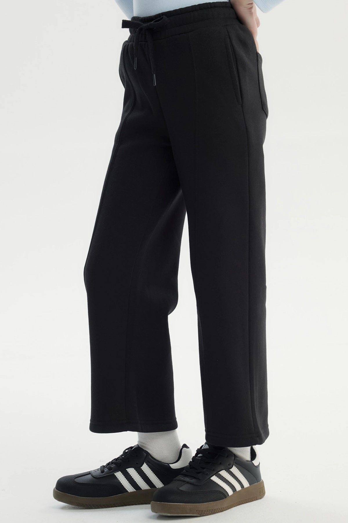 Pantalón buzo negro para niña de pierna ancha sin estampa con cintura elástica y ajuste con cordón