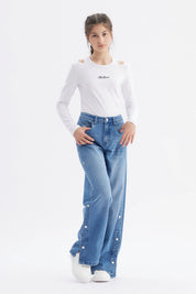 Jeans niña wide leg azul con botones en el costado y corte holgado sin estampa visibles en la imagen