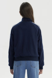 Chaqueta azul marino para niña con cierre y cuello alto detalles de líneas blancas en las mangas diseño deportivo liso
