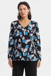 Polera mujer negra con estampado floral en azul y blanco estilo cruzado con hebilla decorativa a la altura de la cintura