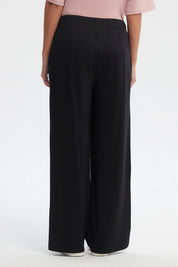 Pantalón buzo negro mujer calce recto con ojales decorativos en los costados diseño liso