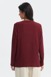 Polera de mujer color rojo con detalle metálico en el cuello sin estampa visible diseño liso elegante y moderno