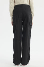 Pantalón cargo negro para niño con bolsillos grandes y cortes visibles diseño liso estilo casual urbano