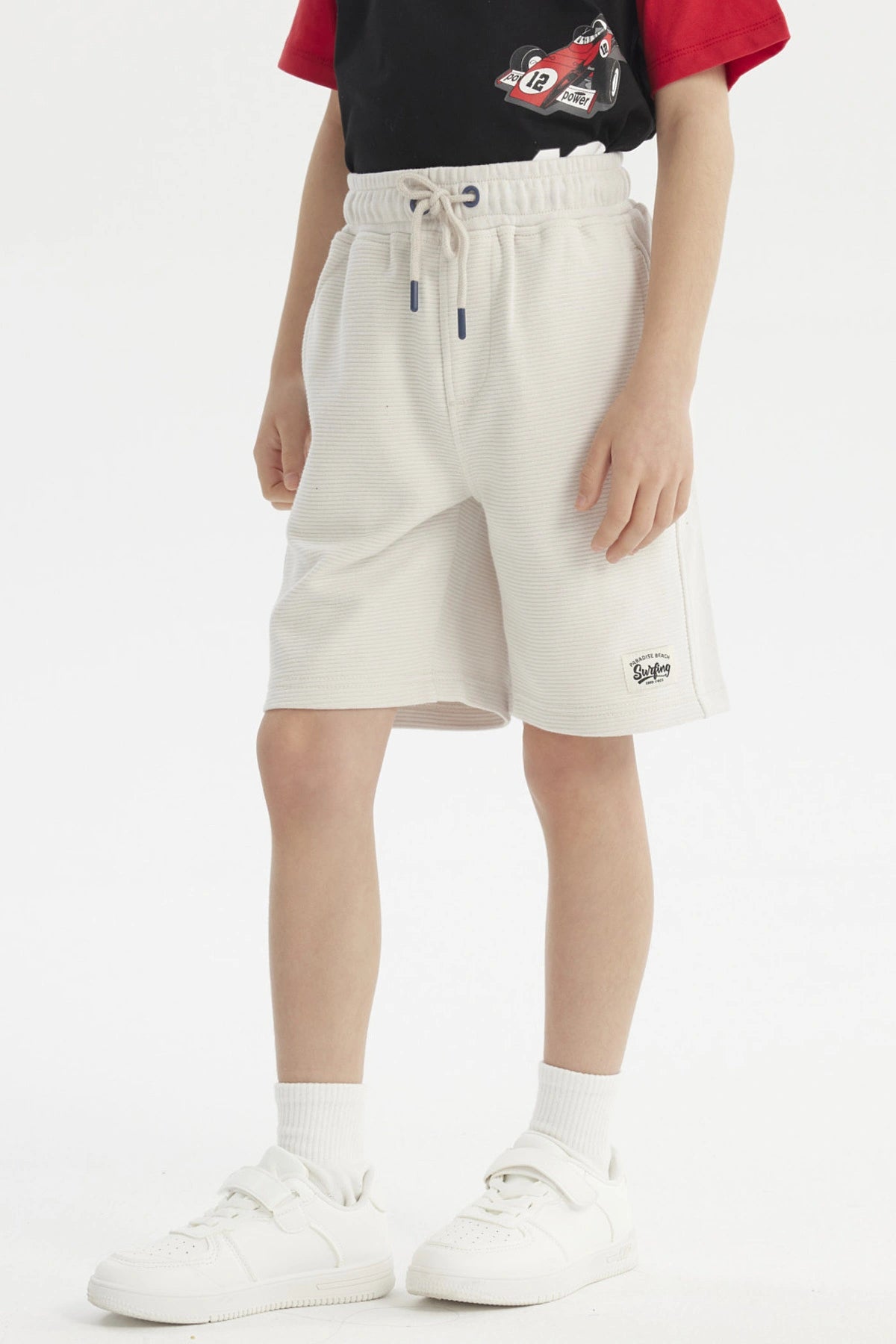Bermuda niño color crudo con textura acanalada lisa ajuste con cordón y bolsillos laterales para estilo casual cómodo