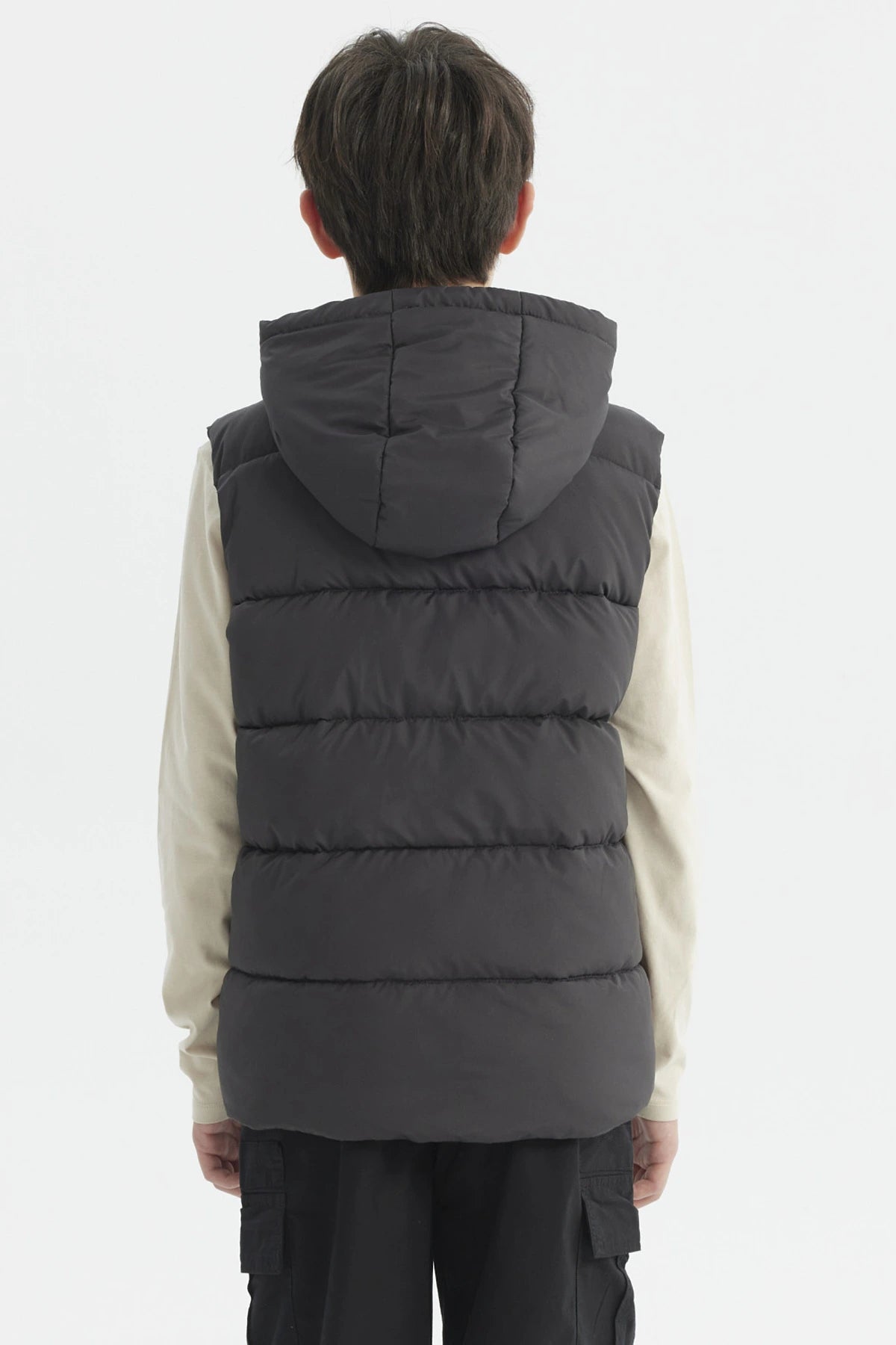 Parka de niño color marengo con gorro acolchado y parche circular en el pecho estilo urbano