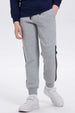 Pantalón buzo niño gris melange con rayas lateral