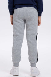 Pantalón buzo niño gris melange con rayas lateral