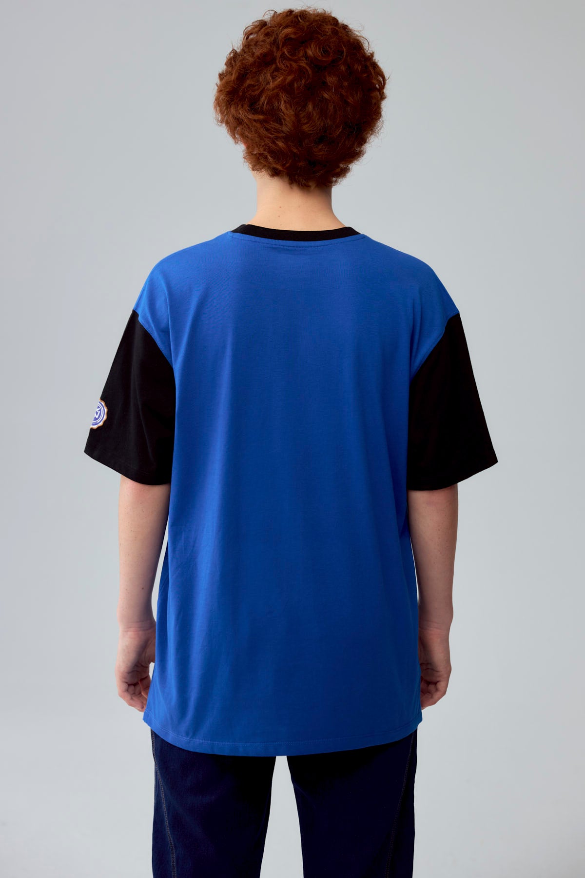 Polera azul con estampado de baloncesto y texto Athletics en el frente