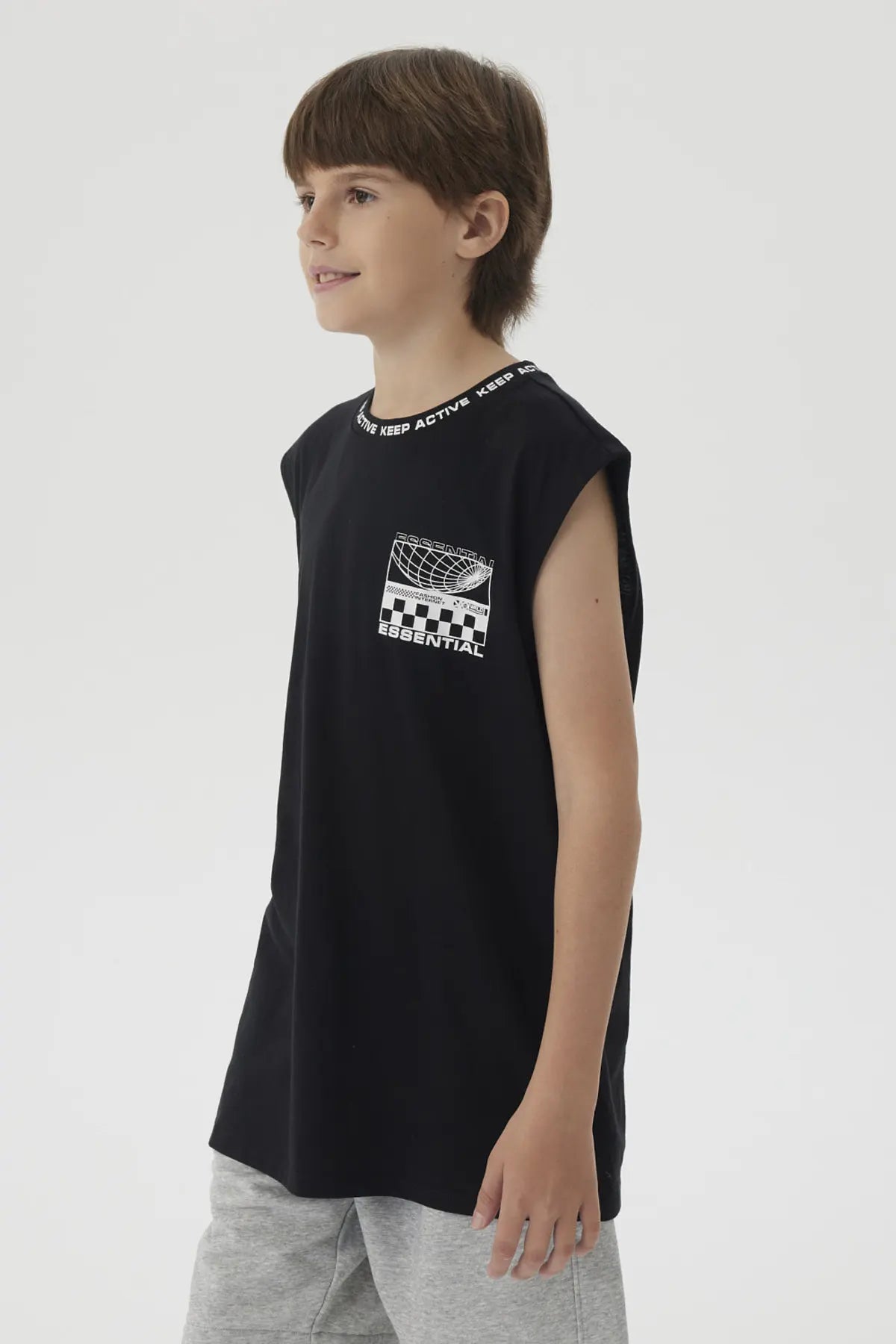 Polera negra de niño con cuello rib y diseño gráfico pequeño en el pecho estilo moderno y texto Keep Active