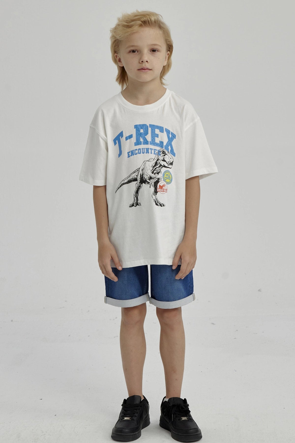 Polera de niño crudo con estampado de T-Rex en el centro en estilo gráfico vintage