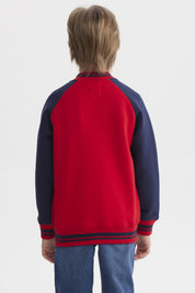 Chaqueta niño rojo con cuello V y mangas azul marino diseño dinosaurio en el pecho estilo casual divertida y cómoda