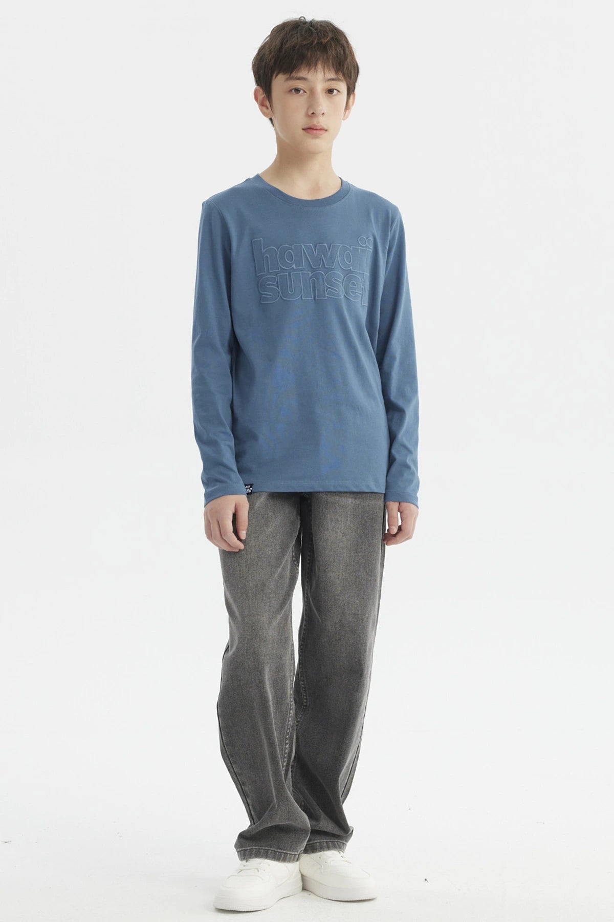 Polera azul petróleo para niño con texto Hawaii Sunset en relieve al frente de estilo casual y manga larga lisa