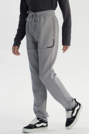 Pantalón buzo pitillo gris liso con cintura elástica y cordón frontal para niño