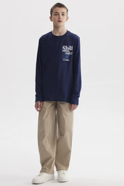 Pantalón baggy beige para niño con cintura elástica diseño liso cómodo y versátil ideal para el día a día