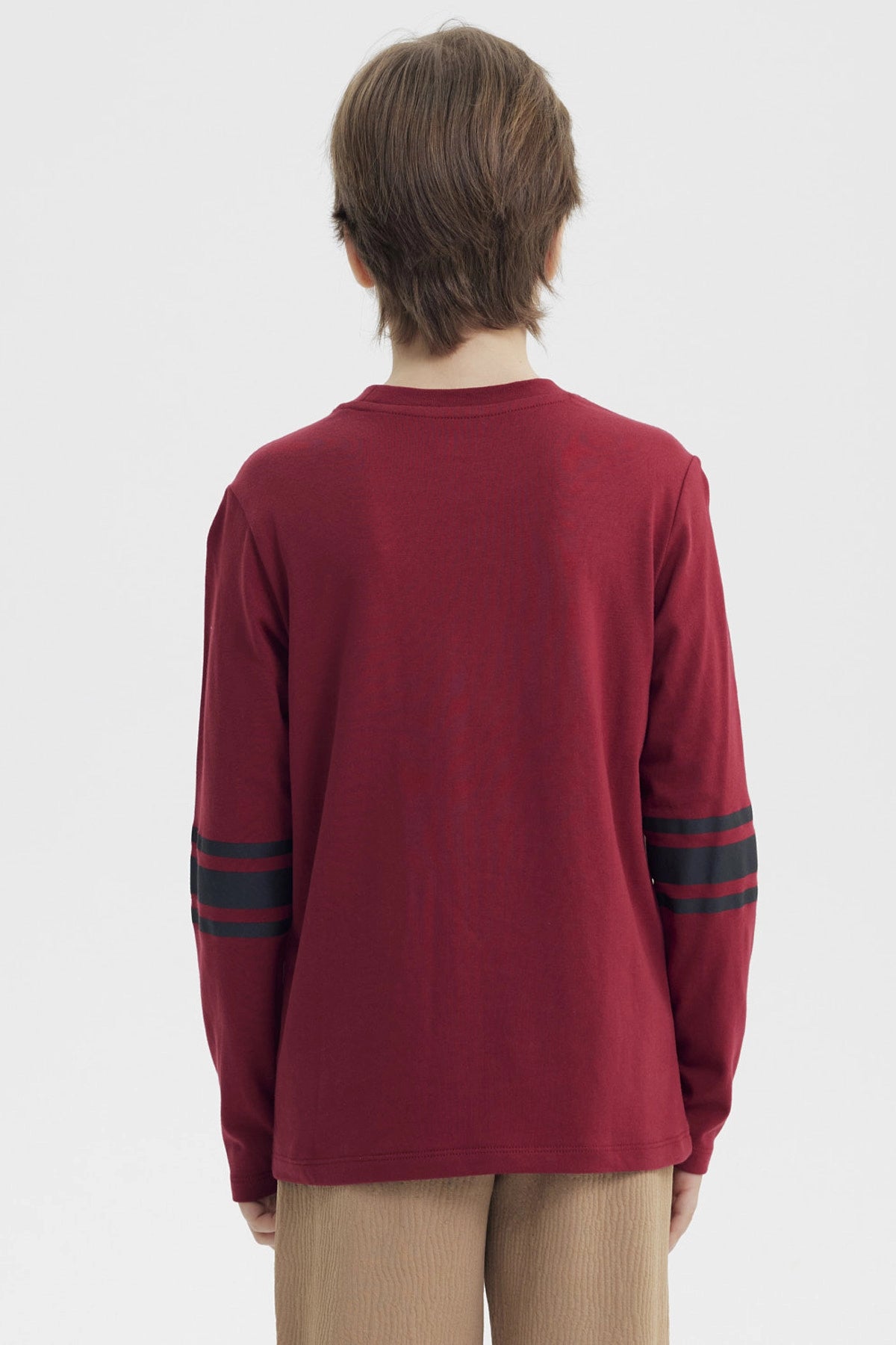 Polera de niño burdeo con estampado frontal de texto y símbolos coloridos estilo casual y moderno sin estampado trasero