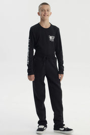 Pantalón buzo niño negro con cintura elástica y cordones ajustables prenda lisa ideal para días activos
