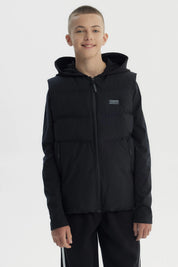 Parka sin mangas negra para niño con capucha y cierre frontal diseño liso ideal para el frío urbano