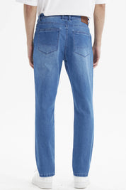 Jeans slim azul para hombre con diseño liso corte ajustado y efecto deslavado ligero en las piernas