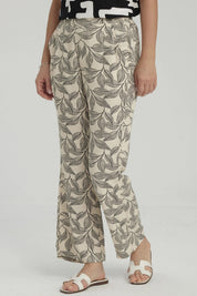 Pantalón pescador beige con estampado de hojas negras grandes estilo gráfico ocupando toda la prenda