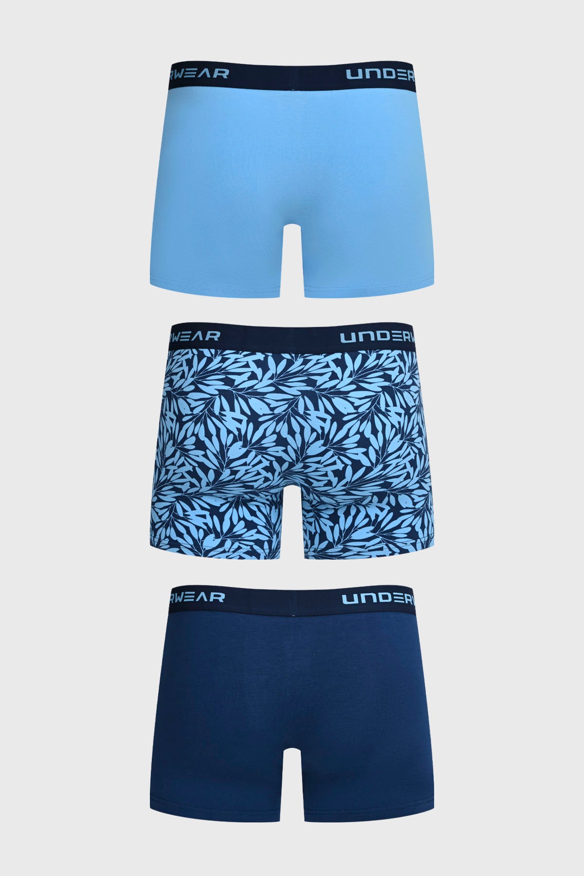 Boxer hombre tripack azul con diseño liso y hojas tropicales en estampado gráfico mediano al centro