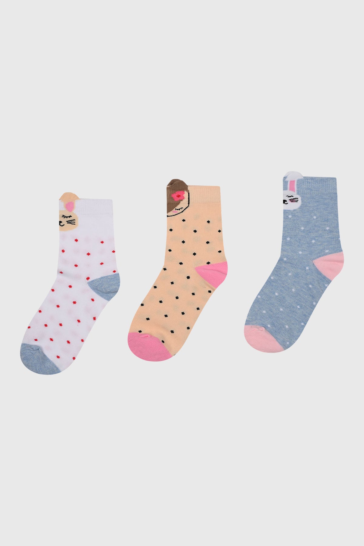 Tripack de calcetines para niña azul con diseños de conejitos en el puño sobre fondo de lunares estilo divertido