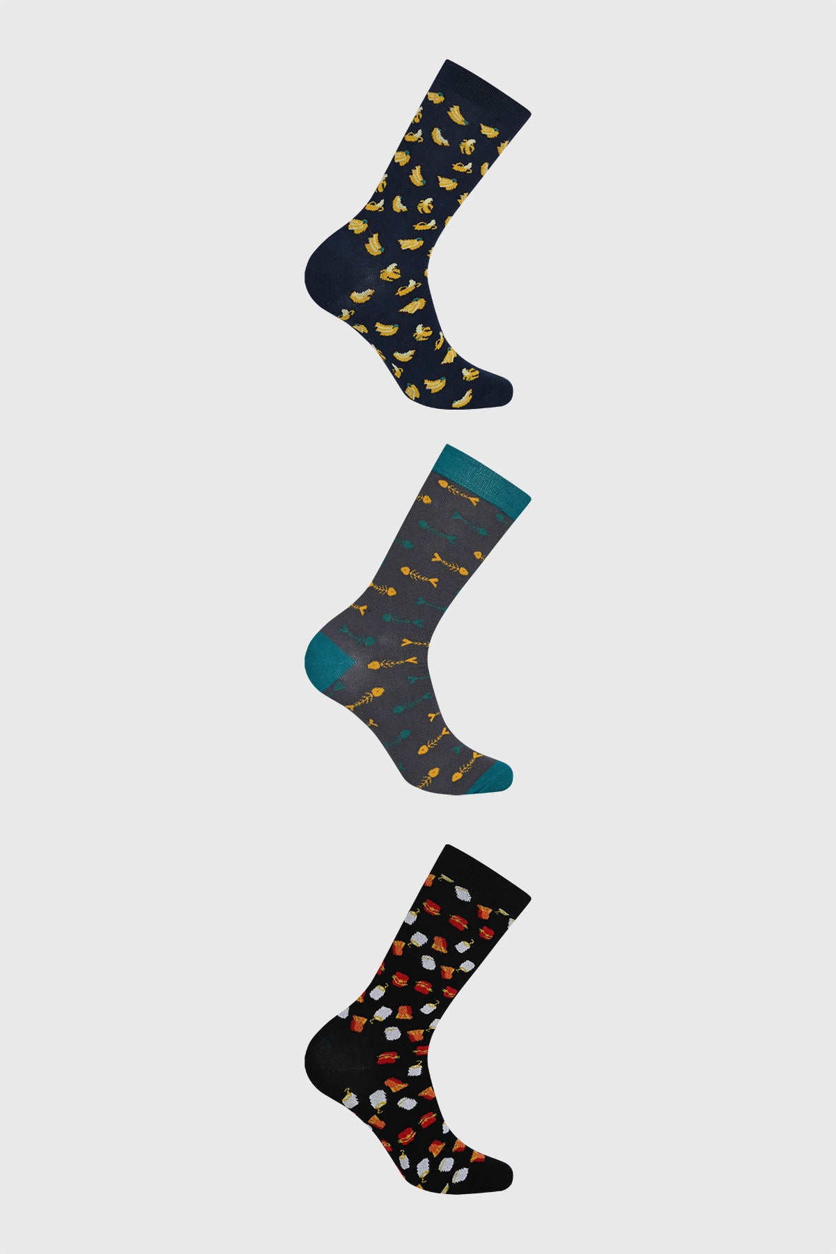 Tripack de calcetines negros para hombre con estampado colorido de plátanos flechas y animales distribuidos uniformemente