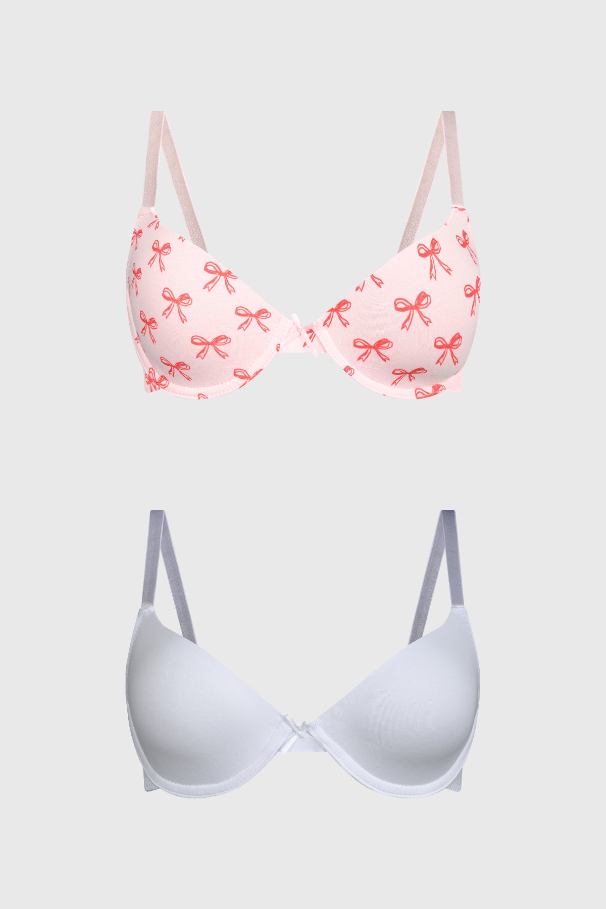 Bipack de sostenes mujer rojo uno con estampado de lazos rojos pequeños repetidos y otro liso en diseño clásico