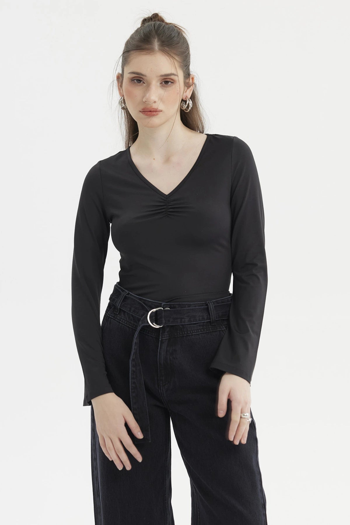 Polera negra de mujer con escote en V y recogido central diseño liso de manga larga ideal para un look casual elegante