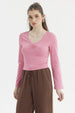 Polera rosa de mujer con escote en V y recogido al frente manga larga y diseño liso ideal para el día a día