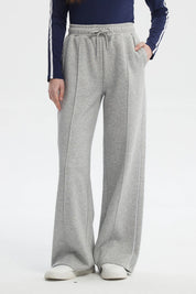 Pantalón buzo mujer gris melange estilo wide leg con cordón ajustable sin estampa visible diseño liso cómodo y moderno
