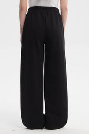 Pantalón buzo mujer negro con corte wide leg y cintura elástica prenda lisa ideal para un look casual y cómodo
