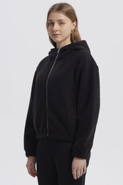 Polar mujer negro con capucha cremallera frontal y diseño liso ideal para el invierno