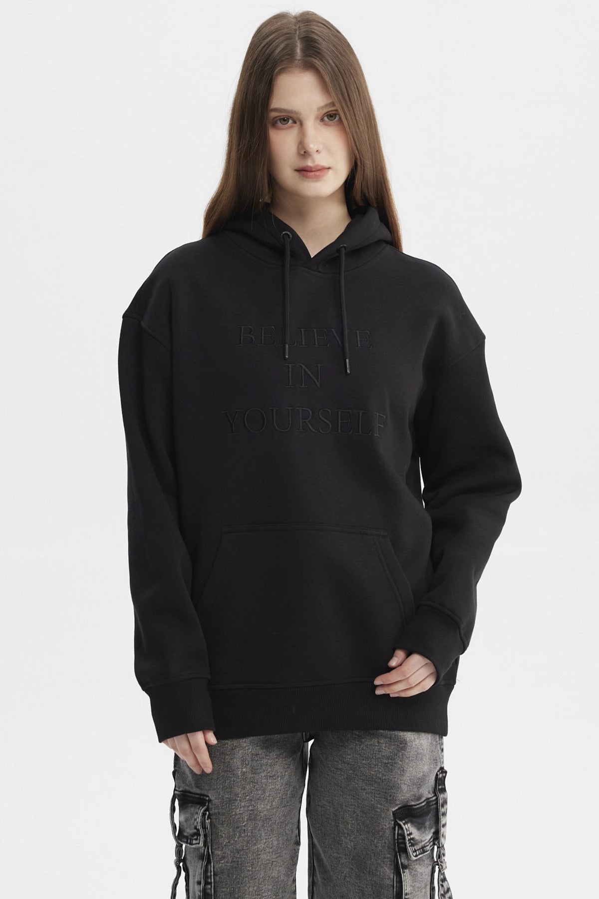 Polerón negro mujer con capucha y bolsillo canguro estampado Believe in Yourself en el pecho estilo casual urbano