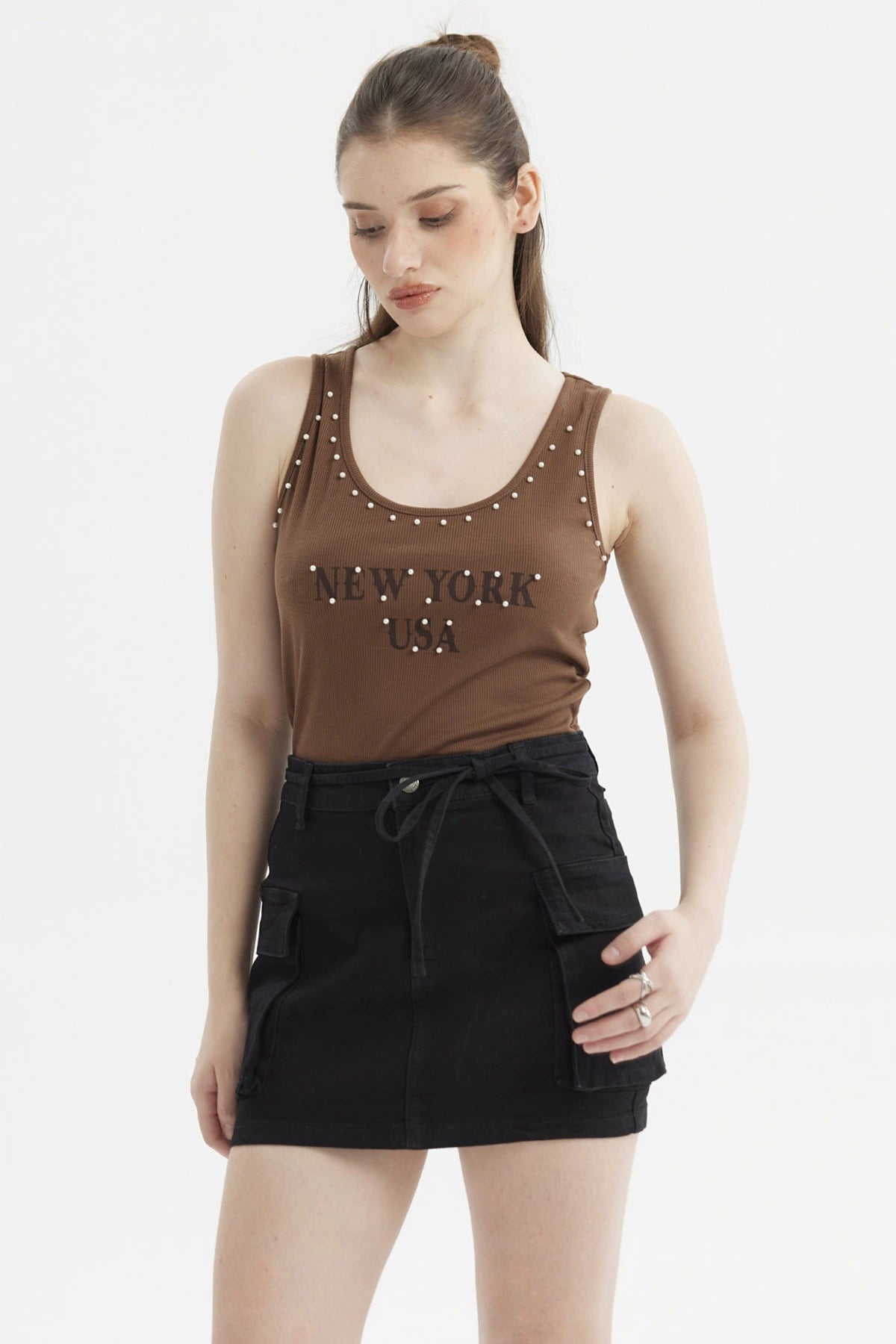 Polera café oscuro para mujer con ribetes y rivets en los hombros estampado frontal New York USA estilo casual urbano