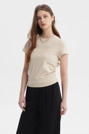 Polera ajustada beige oscuro con texto BEST WISH en el pecho en letras brillantes estilo minimalista sin estampa adicional