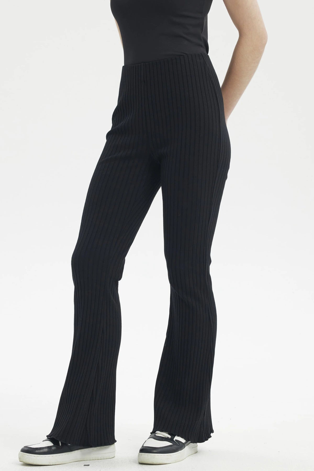 Pantalón flare negro de mujer con diseño acanalado vertical sin estampa visible cómodo y elegante