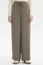 Pantalón mujer holgado verde militar claro con cordón ajustable en la cintura prenda lisa estilo relajado y versátil