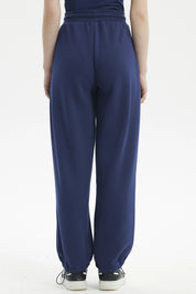 Pantalón buzo mujer pitillo azul sin estampa ajustado con cordón a la cintura y bolsillos laterales corte casual