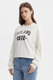 Polerón crudo mujer crop con texto Milano 1972 en el pecho estilo casual y urbano ideal para looks relajados