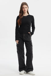 Polera negra de mujer con recogido lateral sin estampa lisa y manga larga ajuste moderno y casual