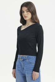 Polera negra de mujer con cuello asimétrico y manga larga lisa