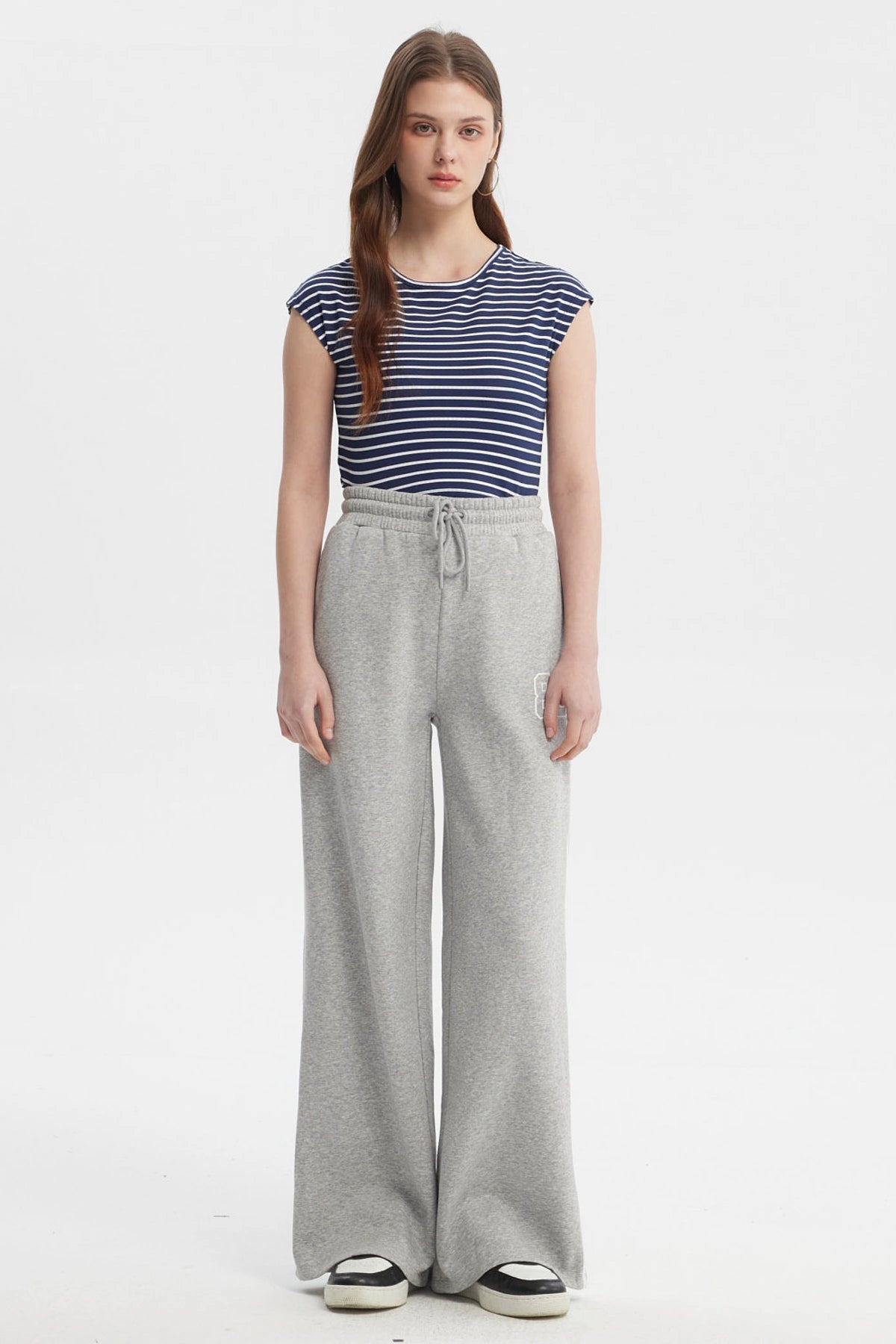 Pantalón buzo gris melange para mujer con cintas blancas a los costados diseño número 89 pequeño en el muslo izquierdo