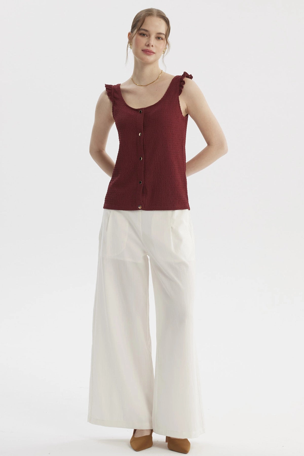 Polera sin mangas color vino con botones dorados y detalles de vuelo en los hombros lisa elegante y moderna
