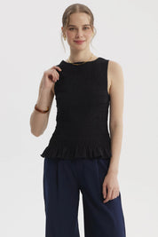 Blusa negra sin mangas con textura panal y vuelo en el bajo prenda lisa elegante para combinar con todo
