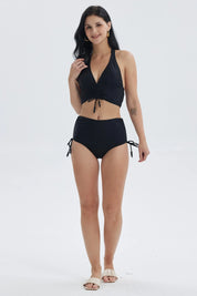 Traje de baño negro de mujer con peto y escote en V