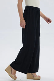 Pantalón mujer negro con textura y pretina elástica visible