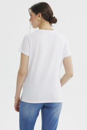 Polera blanca de mujer con texto 'SUNDAY' grande y 'NO ALARM JUST ALMOND LATTE' debajo en el pecho estilo casual