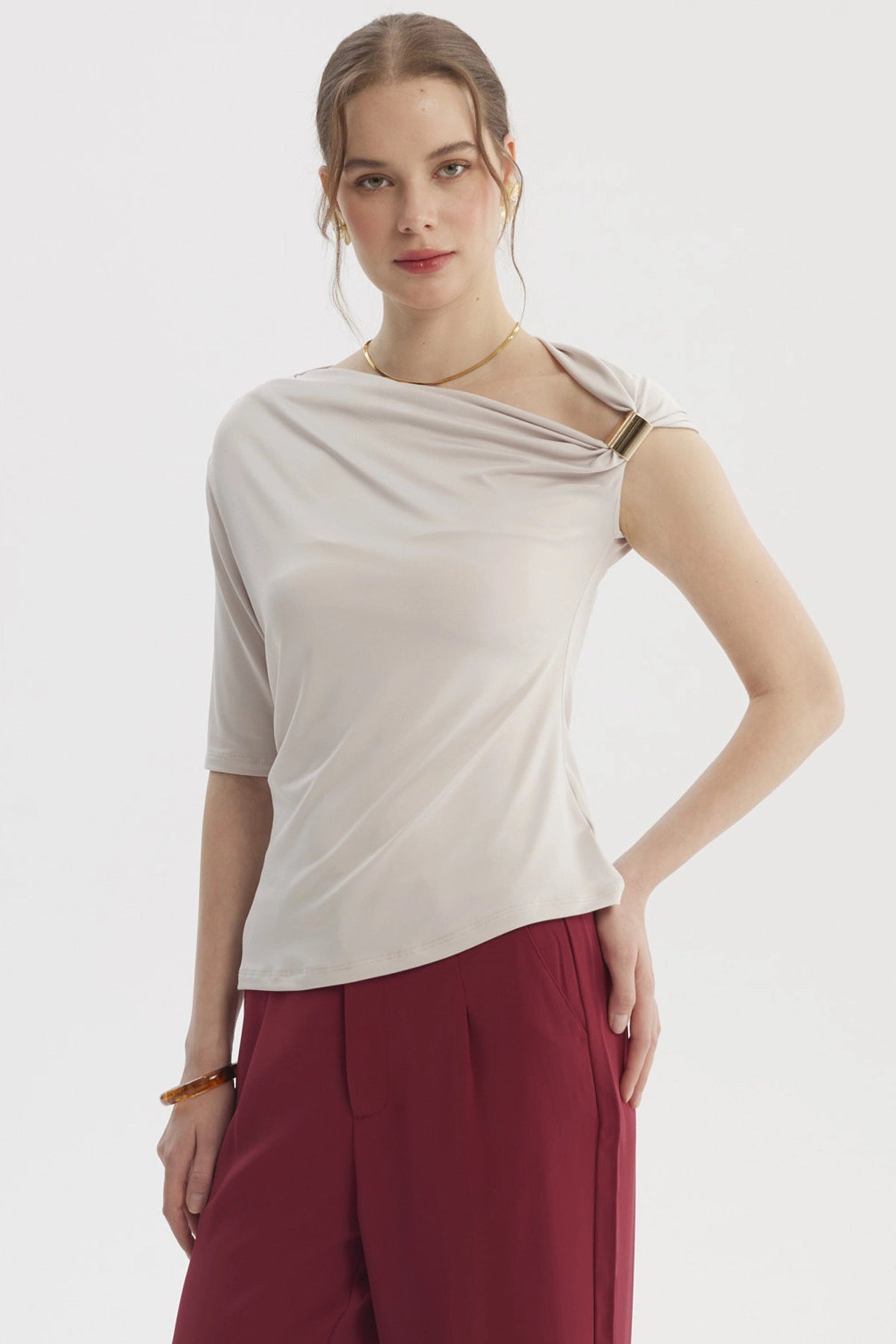 Polera asimétrica arena para mujer con detalle en el hombro y manga corta diseño liso elegante y moderno