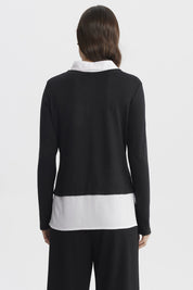 Sweater negro con blusa blanca falsa visible en cuello y faldón diseño liso ideal para un look elegante y moderno