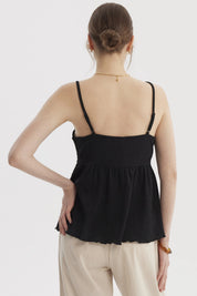 Peto negro de mujer con escote calado y botones decorativos en el frente diseño de tirantes delgados estilo casual